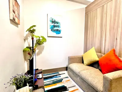 a living room with a couch and a table at SMDC Apartment Ortigas in Manila