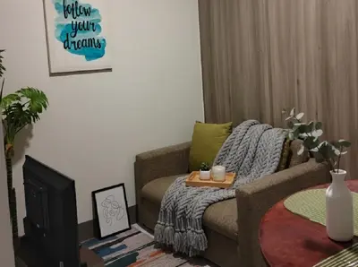 a living room with a couch and a coffee table at SMDC Apartment Ortigas in Manila