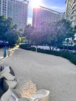 a beach with chairs and buildings in a city at Azure Staycation Condo Unit in Manila