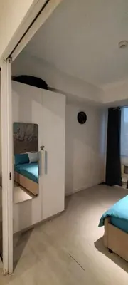 a bedroom with two beds and a door to a room at Azure Cozy Vibe Condo Unit in Manila