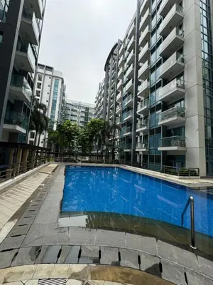 an empty swimming pool in front of tall buildings at Alaya Place - Palm Tree II - in front of NAIA 3 in Manila