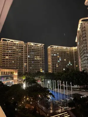 a view of a city at night with tall buildings at Staycation in Azure Paranaque in Manila
