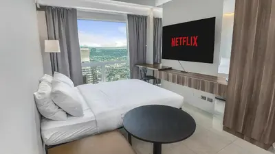 a hotel room with a bed and a television at Sky Suite Makati Modern Penthouse near Greenbelt in Manila