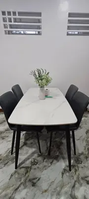 a white table with chairs and a vase with a plant at Family Unit at Mary's Staycation in Tanza Cavite Condo Type good for 4 person in Tanza