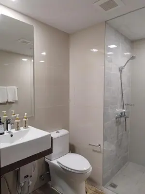 a bathroom with a toilet and a sink and a shower at Savvy Suite 1BR near Okada in Manila