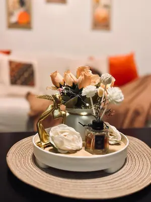 a plate with a vase with flowers on a table at La Chicka Staycation -1292 in Manila