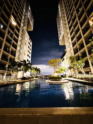 a swimming pool in the middle of two tall buildings at La Chicka Staycation -1292 in Manila