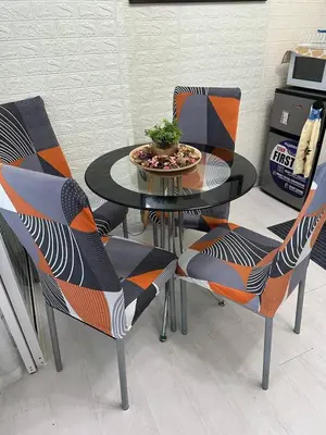 a dining room table with chairs and a plant on it at Uno Tahanan Azure in Manila
