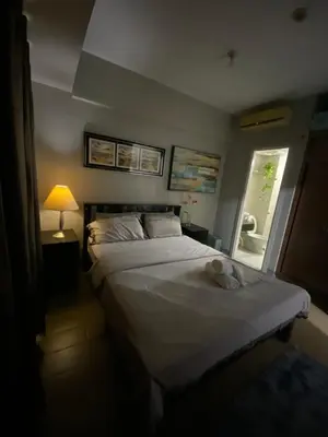 a bedroom with two beds and a window at JNL Condotel in Manila
