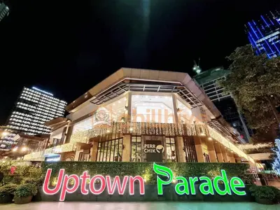 a building with a neon sign in front of it at Prime 1br Condo Infront Grand Hyatt BGC #oursw20d1 in Manila