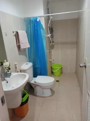 a bathroom with a toilet and a sink at Urban haven Family&Barkada room in Manila