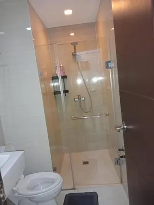 a bathroom with a shower and a toilet at Newport 101 - East Wing in Manila