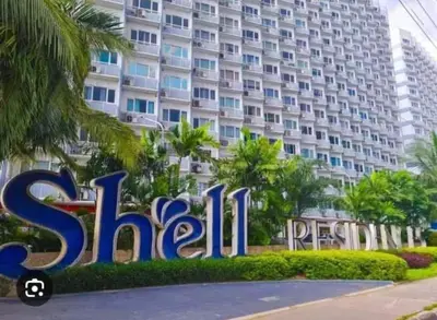 a sign in front of a large building at Shell Residences in Manila