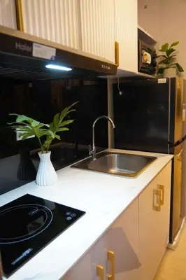 a kitchen with a sink and a black microwave at NEAR NAIA TERMINAL 1, 2, 3 Cozy Apartment at Field Residence in Manila