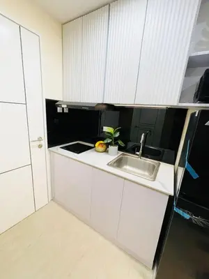 a kitchen with white cabinets and a sink at NEAR NAIA TERMINAL 1, 2, 3 Cozy Apartment at Field Residence in Manila