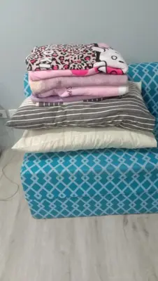 a stack of pillows sitting on top of a bed at Josephine Macatula in Santa Rosa