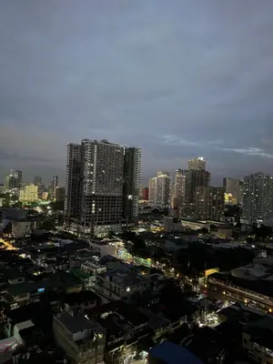 a view of a city with tall buildings at night at 2 bedroom Haven in Manila