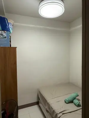 a small room with a bed and a light at 2 bedroom Haven in Manila