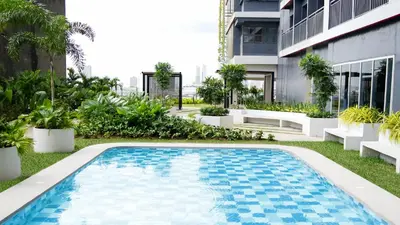 a swimming pool in the yard of a building at Homefort Twin Bed Suite - Red Residences Makati 1146 in Manila