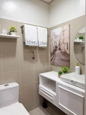 a bathroom with a sink and a mirror at Homefort Twin Bed Suite - Red Residences Makati 2202 in Manila