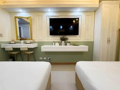 a bedroom with two beds and a sink and a tv at Homefort Twin Bed Suite - Red Residences Makati 2202 in Manila