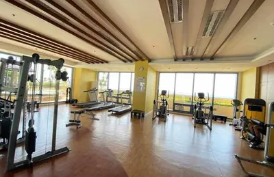 a gym with several treadmills and exercise bikes at Family budget room, infront US of Embassy in Manila