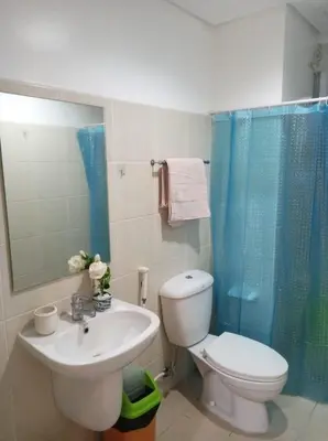 a bathroom with a sink and a toilet and a shower at Cozy simple 1 bedroom in Manila