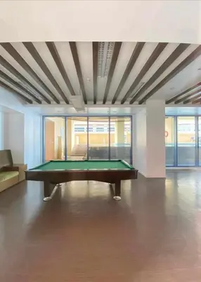 a pool table in a room with a ceiling at Cozy simple 1 bedroom in Manila