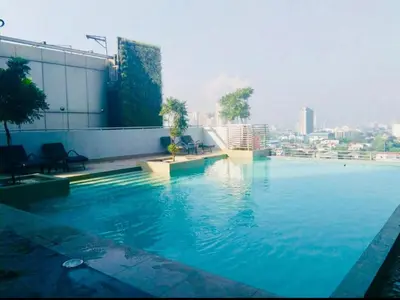 a large swimming pool on top of a building at Pent House for Your Staycation in Manila