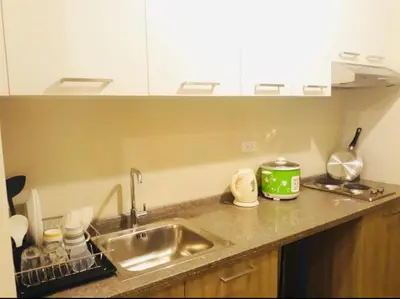 a kitchen with a sink and a counter top at Pent House for Your Staycation in Manila