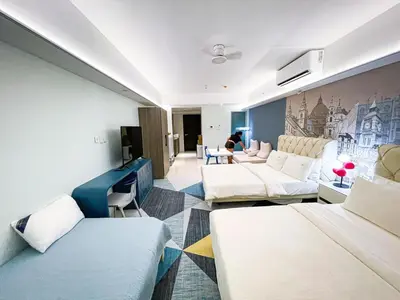 a living room with white couches and a tv at Lovely Penthouse near Airport, City of Dreams 8pax in Manila