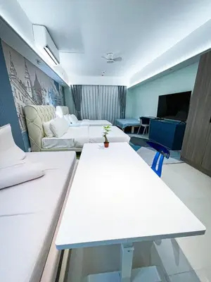 a hotel room with two beds and a couch at Lovely Penthouse near Airport, City of Dreams 8pax in Manila