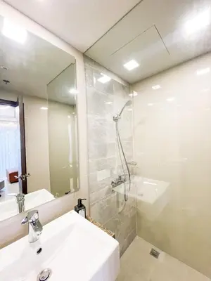 a bathroom with a sink and a shower and a mirror at Cozy 3BR in Manila Bay near Okada II 12pax in Manila