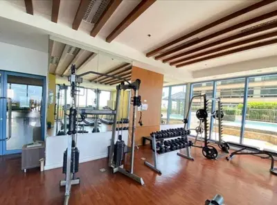 a gym with treadmills and ellipticals in a building at Studio type unit 1, infront of US Embassy Manila in Manila