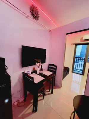 a dining room with pink walls and a table with a cat on it at Mavic Staycation in Manila