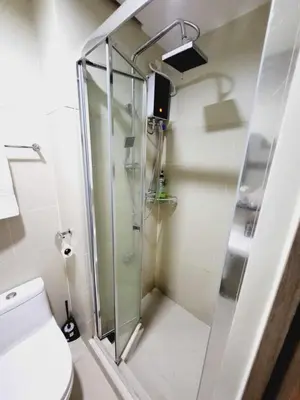a shower with a glass door in a bathroom at Mavic Staycation in Manila