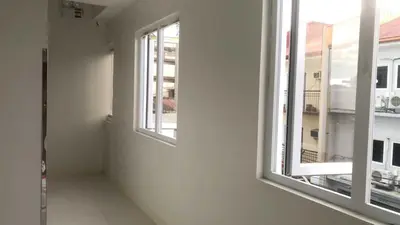an empty room with two windows in a building at OYO 1128 HOTEL SANGCO in Manila