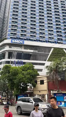 a group of people walking in front of a large building at Destina at Air Residences Makati MetroManila, Netflix in Manila
