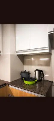 a kitchen with a counter top with two pots and pans at One winstar realty corp in Manila