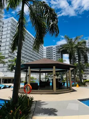 a gazebo in front of a large building at 729A Near MOA and Airport PoolView Balcony in Manila