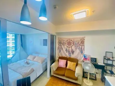a bedroom with a bed and a couch at Sole Sisters Staycation in Manila