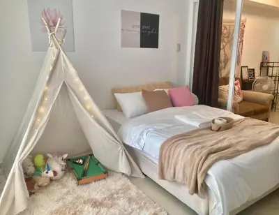a bedroom with a bed with a tent in it at Sole Sisters Staycation in Manila