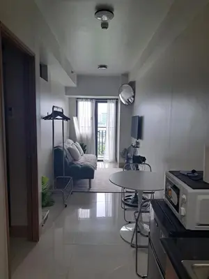 a living room with a table and a couch at Yutori Haus at Shore 3 Tower 2 near Mall of Asia Pasay City in Manila