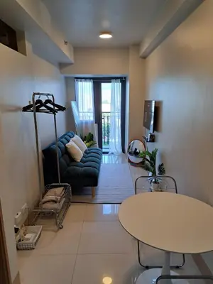 a living room with a couch and a table at Yutori Haus at Shore 3 Tower 2 near Mall of Asia Pasay City in Manila
