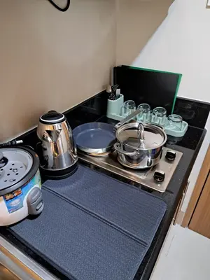a stove top with pots and pans on it at Yutori Haus at Shore 3 Tower 2 near Mall of Asia Pasay City in Manila