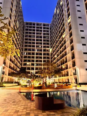 a large building with two tall buildings at Iris Suites in Manila
