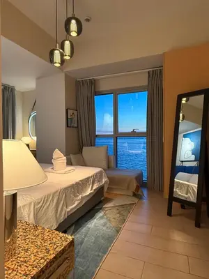 a hotel room with a bed and a large window at Luxurious Style Apartment cross to Okada and near City of Dreams, Solaire, MOA, and Airport in Manila