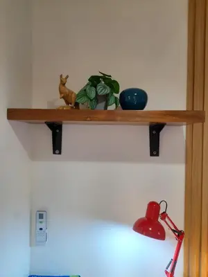 a shelf with a plant and a tea pot on it at Cali Suite - Nuvali in Pitland