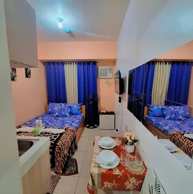 a small room with two beds and a kitchen at G and A CONDOTELS in Manila