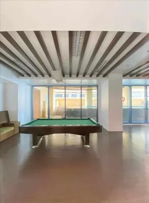 a pool table in the middle of a room at Cozy Studio typeunit in Manila